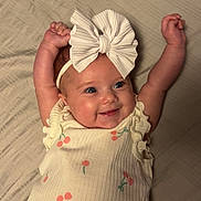 Hazel joined the competition — help win amazing prizes! baby, infant, smile, happy, cute, headband, bow, cherry_pattern, diaper, sleeveless_top, lying_down, bed, blanket, skin, arms_up, cheeks, portrait, child, clothing, indoor