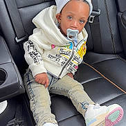 Nehemiah joined the competition — help win amazing prizes! toddler, child, car_seat, leather_seat, hoodie, beanie, pacifier, sneakers, jeans, fashion, casual, cute, baby, portrait, indoor, seatbelt, car_interior, person, sitting, young