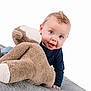 Jackson is registered to the contest to win money with this photo: baby, teddy_bear, plush_toy, blue_eyes, curly_hair, smiling, infant, crawling, soft_blanket, cute, child, toy, indoor, playful, close_up, warm_clothing, adorable, happy, portrait, young_child