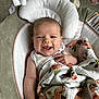 Sabrina is registered to the contest to win money with this photo: baby, infant, smiling, blanket, floral, cushion, baby_seat, face, happy, skin, head, hand, clothing, comfort, indoor, portrait, cute, newborn, expression, relaxation