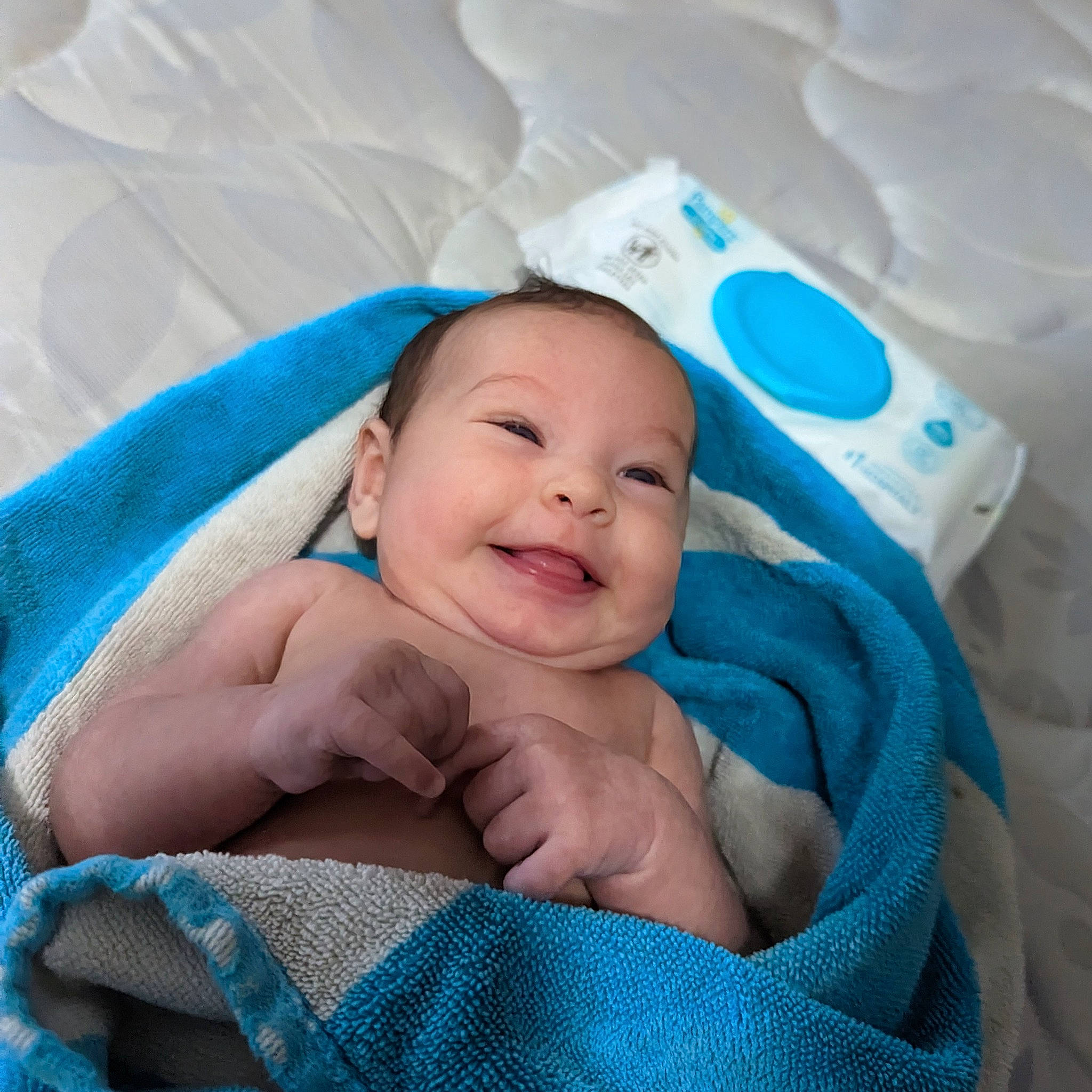 Darcy is registered to the contest to win money with this photo: aqua, azure, baby, baby_products, baby_toddler_clothing, blue, cheek, child, comfort, electric_blue, event, happy, joy, linens, person, product, room, skin, smile, textile