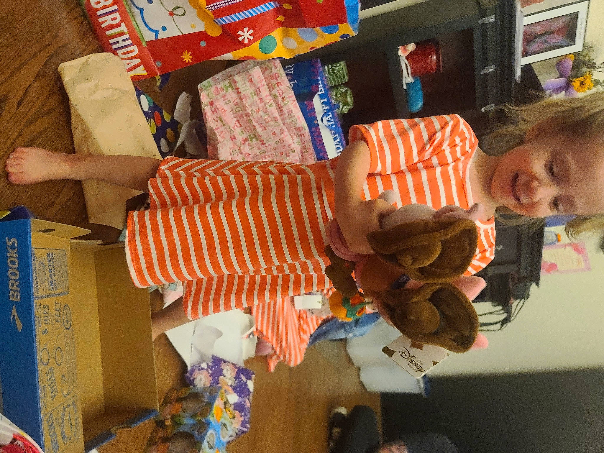 Star is registered to the contest to win money with this photo: child, fun, happy, joy, orange, paper_product, pattern, person, plastic, product, retail, room, shelf, shelving, smile, textile, toddler