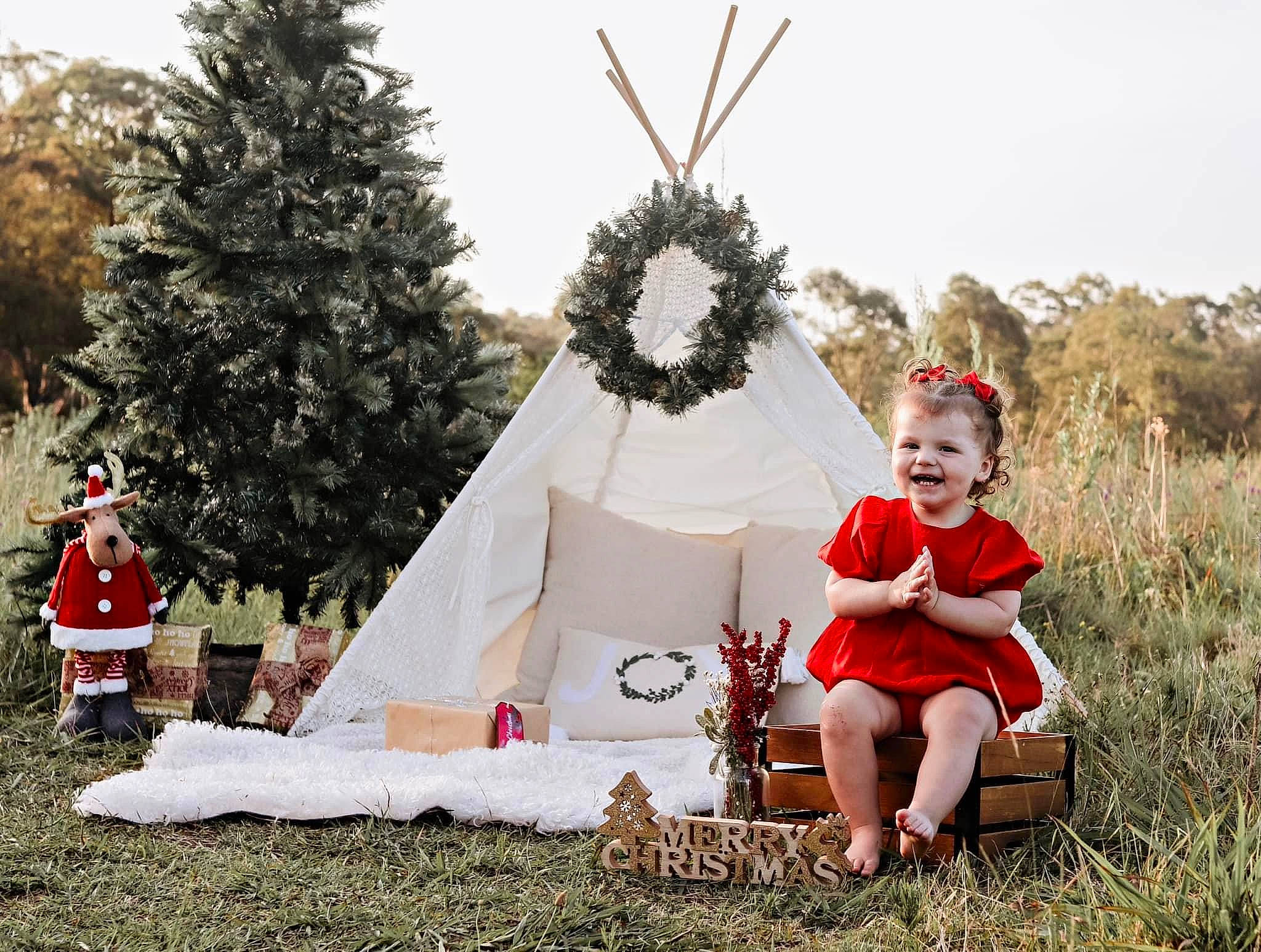 Hallie is registered to the contest to win money with this photo: chair, event, fashion_accessory, fun, grass, happy, joy, leisure, people_in_nature, person, plant, pole, recreation, sitting, sky, smile, sun_hat, tent, toddler, tradition