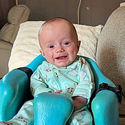 Jonny joined the competition — help win amazing prizes! baby, infant, smiling, onesie, blue_chair, bumbo_chair, indoor, living_room, couch, happy, seat, child, cute, face, person, home, window, air_conditioner, plush, comfort
