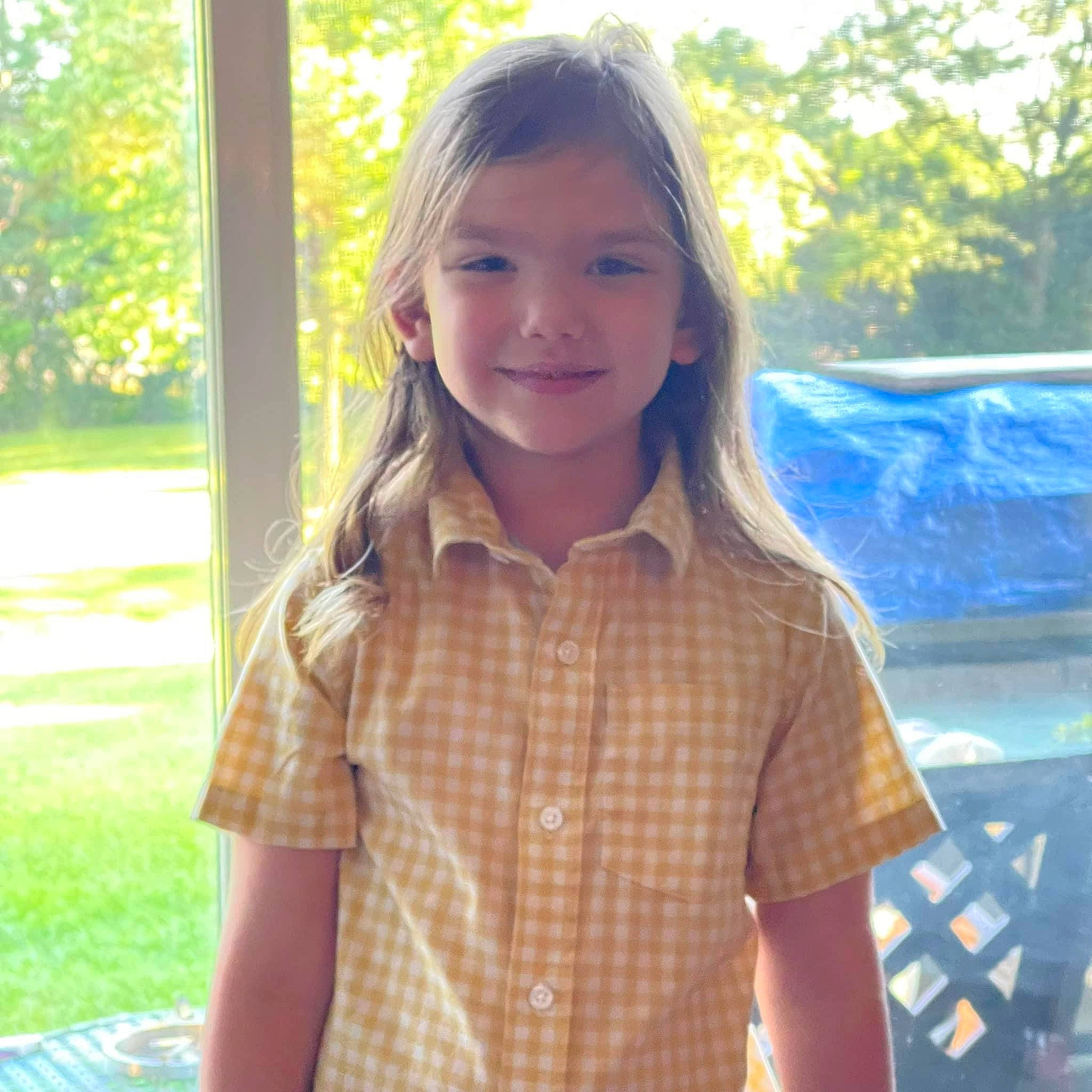 Corey joined the competition — help win amazing prizes! blond, brown_hair, electric_blue, fun, grass, hair, happy, joy, leisure, long_hair, pattern, people_in_nature, person, plaid, plant, recreation, sitting, smile, t_shirt, tartan