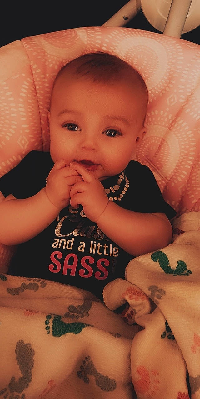 Dolly is registered to the contest to win money with this photo: baby_toddler_clothing, black, cheek, eye, eyelash, face, facial_expression, finger, gesture, hand, head, human, human_body, lip, mouth, neck, nose, person, product, skin