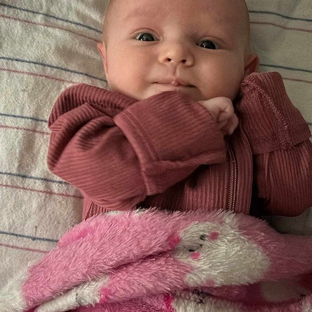Waverly is registered to the contest to win money with this photo: baby, bed, blanket, clothing, cushion, face, furniture, hat, head, homedecor, knitwear, newborn, person, photography, portrait, quilt, sweater, teddybear, towel, toy