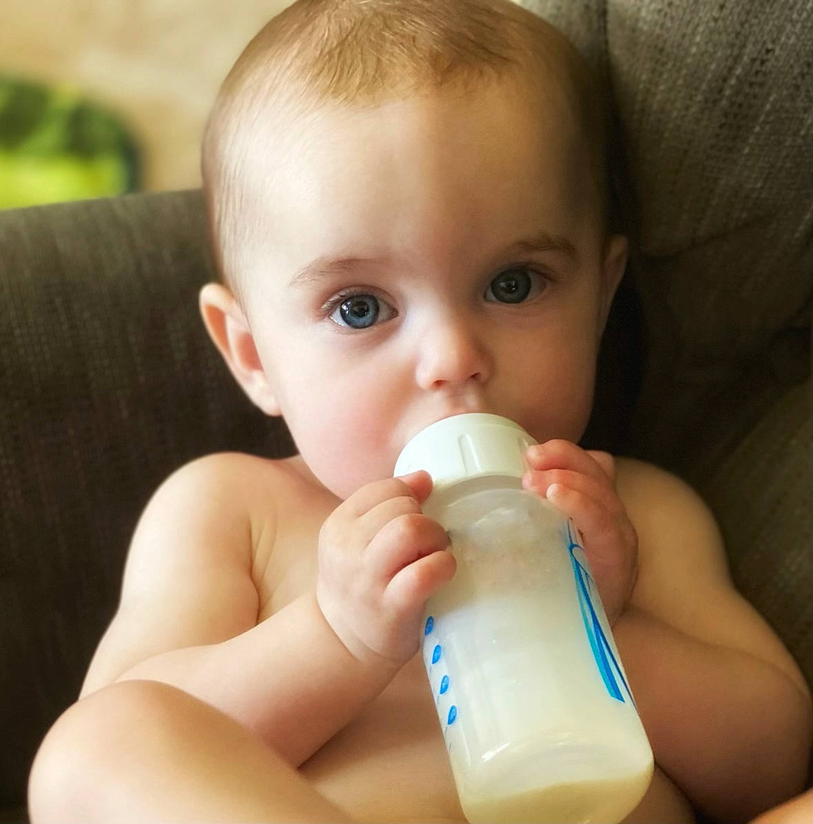 Maddison joined the competition — help win amazing prizes! baby_bottle, bottle, cheek, drinkware, ear, eye, eyebrow, eyelash, finger, fluid, gesture, hand, head, iris, liquid, milk, neck, nose, person, plastic_bottle