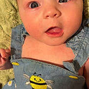 Madeline is registered to the contest to win money with this photo: baby, child, denim, dress, bee, embroidery, cute, face, blue_eyes, skin, clothing, infant, portrait, expression, hand, fabric, yellow, white, flower, soft