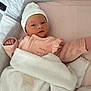 newborn, baby, blanket, pink, hat, infant, bed, sleepwear, soft, cute, cozy, child, face, person, portrait, resting, indoors, sleeping_area, warm, comfort