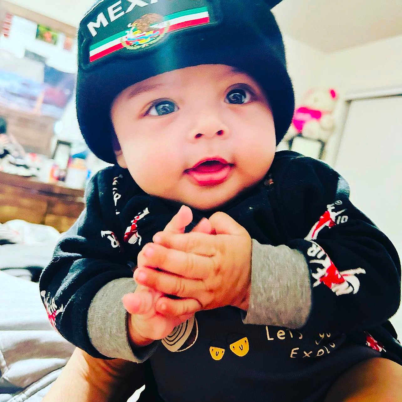 Anthony Casique is registered to the contest to win money with this photo: adorable, apparel, baby, black_beanie, bright_eyes, child, clothing, cute, expression, face, hands, indoor, infant, mexico, person, portrait, sitting, smiling, warm, young