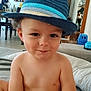toddler, child, hat, fedora, blue, striped, smile, indoor, living_room, toy, diaper, cheeky, face, person, shirtless, curly_hair, home, furniture, couch, playful
