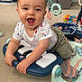 Oscar is registered to the contest to win money with this photo: baby, child, smiling, toy, piano, play_gym, carpet, indoor, clothing, shorts, tshirt, happy, hands, face, person, floor, playtime, colorful, cute, infant
