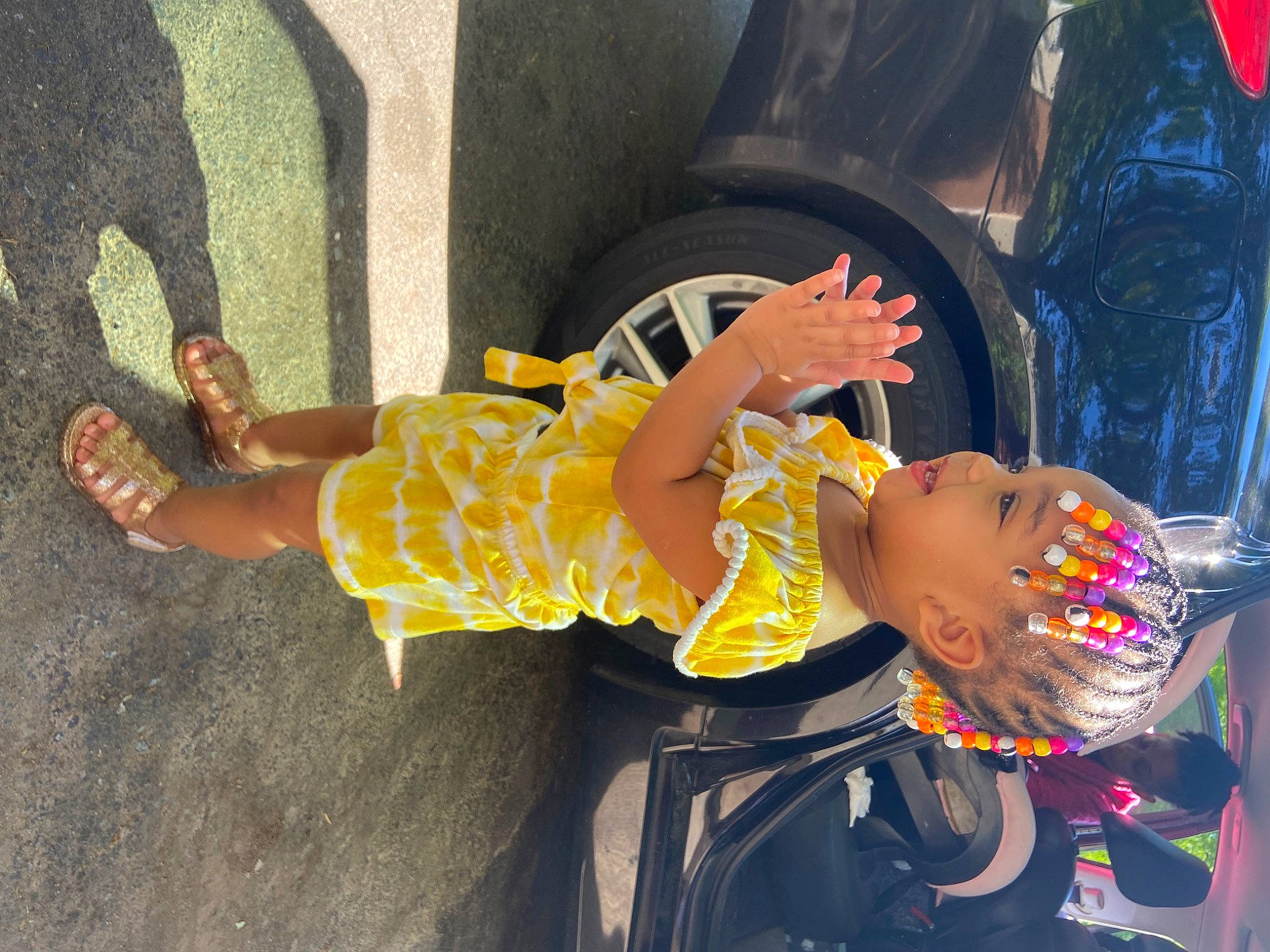Azalea joined the competition — help win amazing prizes! asphalt, automotive_tire, baby, child, flip_flops, foot, fun, happy, hat, headwear, human_leg, knee, leisure, person, sandal, sidewalk, thigh, tire, toddler, vehicle_door