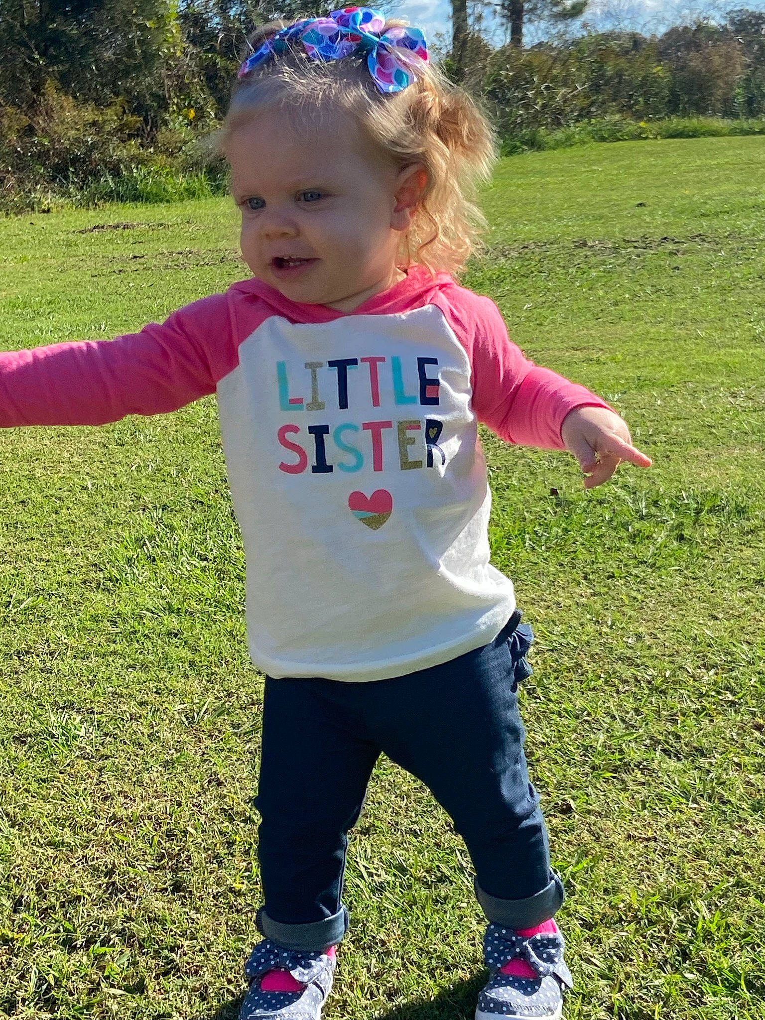 Alana joined the competition — help win amazing prizes! active_pants, baby_toddler_clothing, clothing, cool, eye, face, facial_expression, fun, grass, happy, head, people_in_nature, person, pink, plant, sky, sleeve, smile, standing, summer