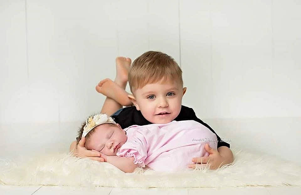 Alana joined the competition — help win amazing prizes! arm, baby, baby_toddler_clothing, cheek, child, collar, comfort, face, flash_photography, foot, fun, gesture, happy, linens, person, sitting, skin, sleeve, smile, t_shirt