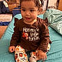 Zhurysadaii joined the competition — help win amazing prizes! bed, brown_shirt, child, clothing, curly_hair, cute, face, furniture, happy, headband, holiday, home, indoor, pants, person, sitting, smiling, sock, thanksgiving, toddler
