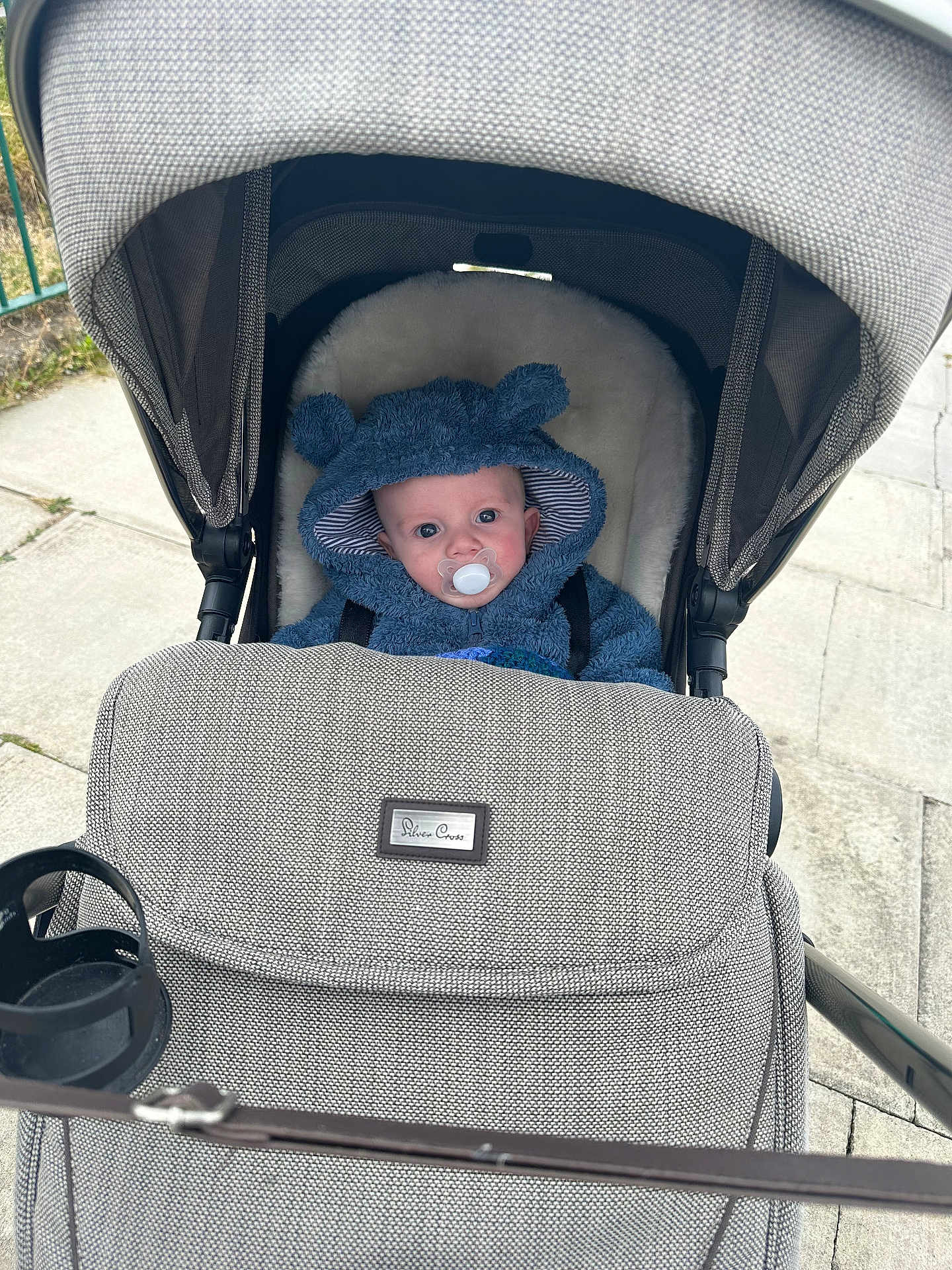 Blake is registered to the contest to win money with this photo: baby, stroller, pacifier, hoodie, blue_hoodie, baby_face, infant, outdoor, sidewalk, cute, child, baby_clothing, baby_accessories, baby_seat, canopy, fabric, person, baby_boy, baby_girl, urban