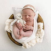Lilly-Mae is registered to the contest to win money with this photo: newborn, baby, infant, sleeping, blanket, wooden_bowl, knitted_toy, teddy_bear, headband, white, soft_texture, fluffy, wrapped, cute, peaceful, portrait, closeup, hand, foot, cozy