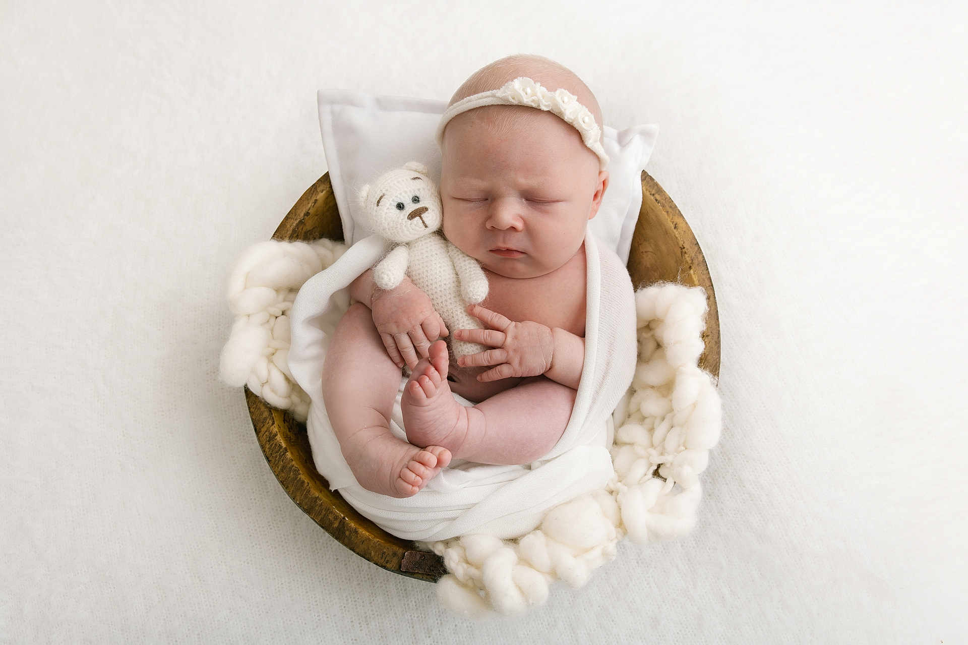 Lilly-Mae is registered to the contest to win money with this photo: newborn, baby, infant, sleeping, blanket, wooden_bowl, knitted_toy, teddy_bear, headband, white, soft_texture, fluffy, wrapped, cute, peaceful, portrait, closeup, hand, foot, cozy
