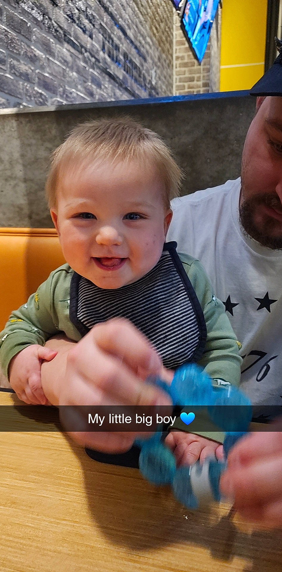 Kade is registered to the contest to win money with this photo: baby, baby_toddler_clothing, blue, cheek, child, electric_blue, finger, fun, gesture, hand, happy, iris, leisure, mouth, nail, person, sitting, skin, smile, thumb