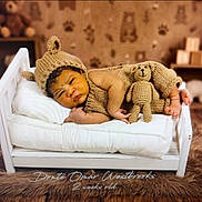 Omar is registered to the contest to win money with this photo: baby, newborn, knitted_hat, knitted_outfit, teddy_bear, mini_bed, pillow, blanket, sleeping, cute, infant, wooden_floor, plush_rug, toy_blocks, background, warm_lighting, portrait, child, cozy, soft_texture
