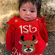 Zayla is registered to the contest to win money with this photo: baby, blanket, carpet, celebration, child, christmas_outfit, cute, festive, holiday, indoors, infant, lying_down, portrait, red_clothing, reindeer, ribbon, smiling, spiky_hair, white_tights, young