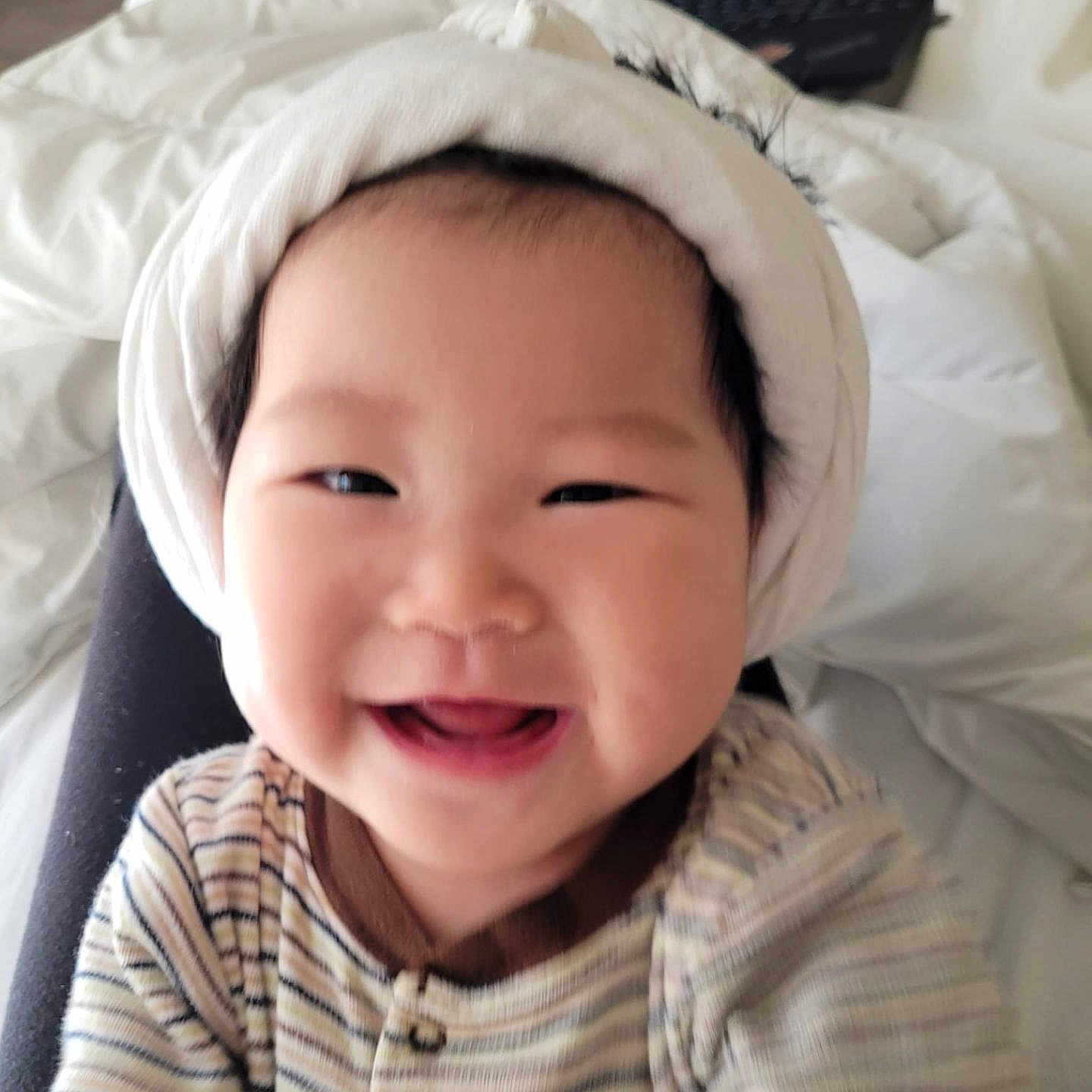 Lyra joined the competition — help win amazing prizes! baby, babylaughing, clothing, computer, cushion, electronics, face, furniture, happy, hat, head, homedecor, hood, laptop, laughing, pc, person, photography, portrait, smile