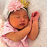 newborn, baby, sleeping, pink_clothing, headband, flower, crown, blanket, soft_texture, peaceful, infant, cute, portrait, closeup, resting, skin, small_hands, indoors, cozy, wrapped