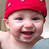 baby, baby_skin, blue_eyes, cheeks, child, close_up, cute, expression, face, happy, headwear, indoors, infant, mouth, person, portrait, red_bandana, skin, smile, teeth