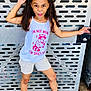 child, girl, pose, pink_bows, white_tank_top, graphic_tshirt, shorts, white_sneakers, black_socks, metal_background, concrete_floor, playful, expression, standing, outdoor, casual_clothing, young, fun, cheeky, raccoon_graphic