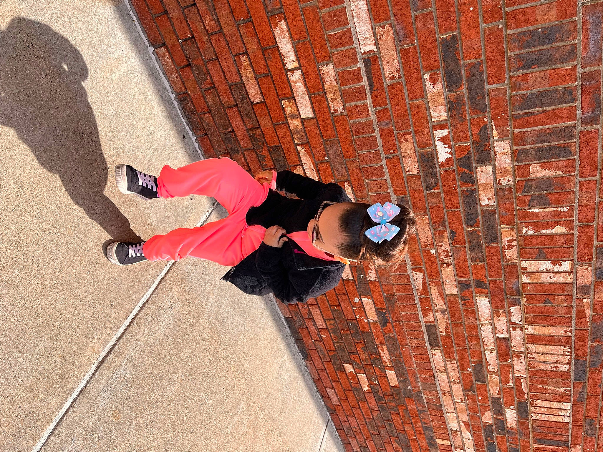 Charli joined the competition — help win amazing prizes! adventure, brick, brickwork, carmine, composite_material, concrete, electric_blue, flooring, footwear, fun, leisure, line, outdoor_shoe, pattern, person, recreation, shadow, sneakers, textile, walking_shoe