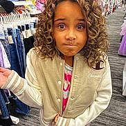 Kyah joined the competition — help win amazing prizes! child, curly_hair, jacket, clothing_store, jeans, rack, curious_expression, standing, indoor, person, casual_wear, shopping, retail, floor, hand_gesture, long_sleeves, young, apparel, store_aisle, portrait