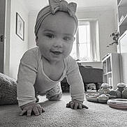 Scarlett is registered to the contest to win money with this photo: baby, black_and_white, bow_headband, carpet, child, clothing, crawling, curtain, cute, face, floor, furniture, hand, home, indoor, living_room, person, smiling, toy, window