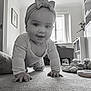 baby, black_and_white, bow_headband, carpet, child, clothing, crawling, curtain, cute, face, floor, furniture, hand, home, indoor, living_room, person, smiling, toy, window