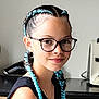child, girl, braids, blue_hair, glasses, smile, portrait, indoor, kitchen, black_top, young, person, hairstyle, face, necklace, fashion, casual, happy, cute, modern