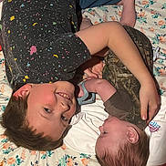 Jaeger joined the competition — help win amazing prizes! child, baby, smiling, bed, floral, blanket, sibling, affection, clothing, toddler, infant, person, home, family, cute, happy, laying, skin, head, hand