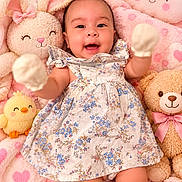 Sabrina joined the competition — help win amazing prizes! baby, infant, smiling, mittens, floral_dress, stuffed_animals, bunny, teddy_bear, chick, cloud_pillow, pink_blanket, heart_pattern, cute, happy, child, soft_toys, portrait, indoors, cozy, playful
