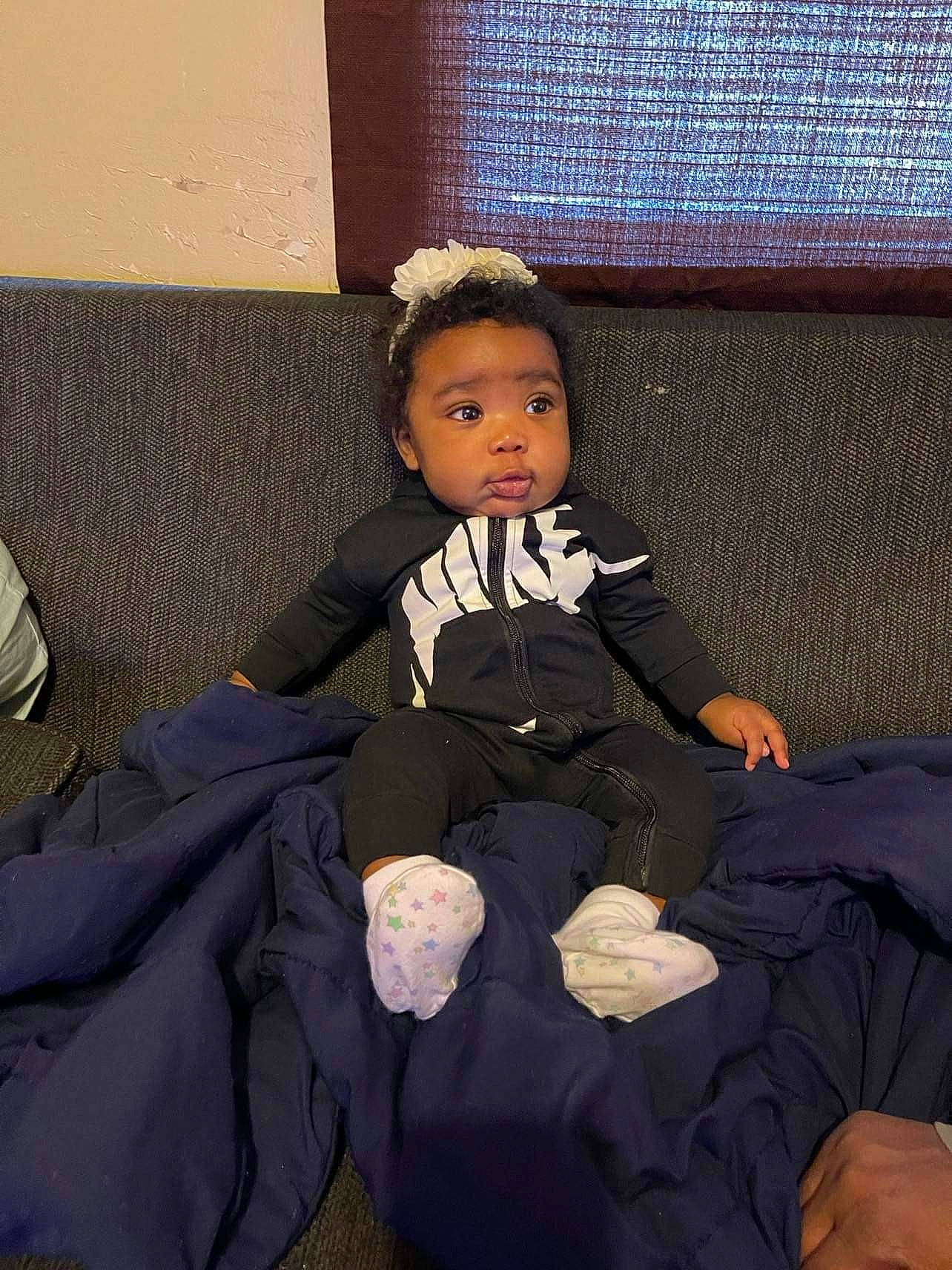 Nezariah is registered to the contest to win money with this photo: baby_toddler_clothing, black_hair, cheek, child, comfort, flash_photography, flooring, foot, formal_wear, fun, human_body, human_leg, lap, person, room, sitting, sock, thumb, tints_and_shades, toddler