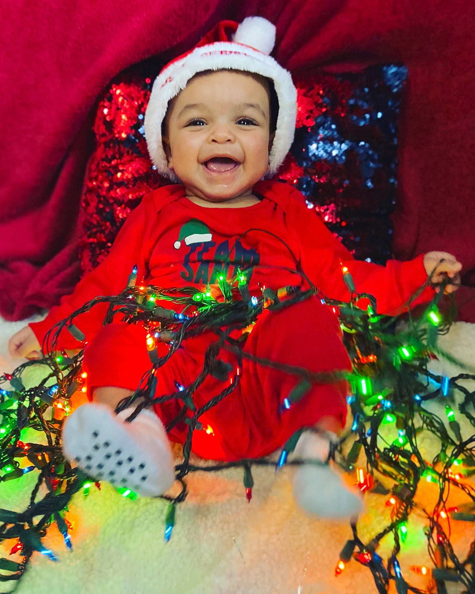 Ermias joined the competition — help win amazing prizes! baby, baby_laughing, baby_toddler_clothing, bicycle_wheel, bonnet, cheek, christmas, christmas_decoration, christmas_eve, costume_accessory, craft, headwear, holiday, hood, laugh, nose, person, pleased, red, toddler