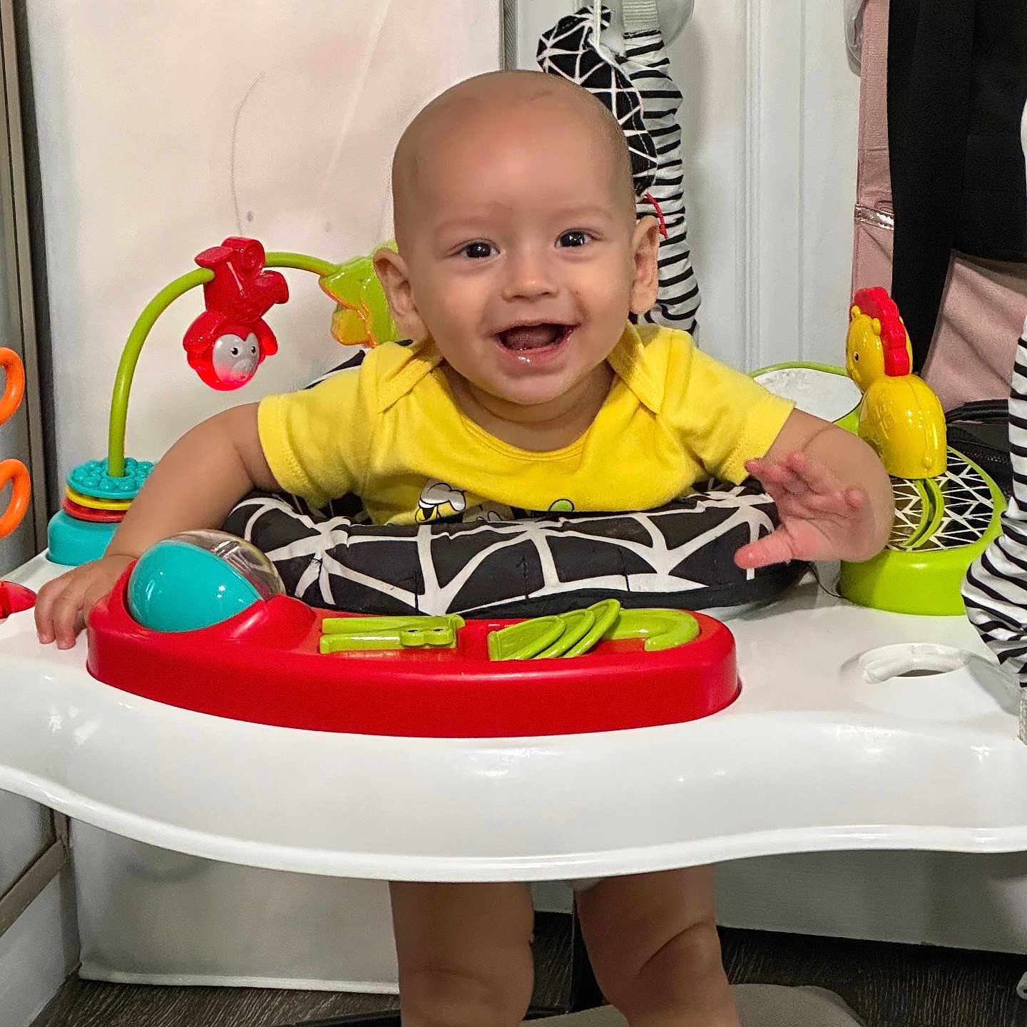 William Gonzalez is registered to the contest to win money with this photo: baby, child, smiling, yellow_shirt, baby_walker, toy, indoor, happy, face, playtime, infant, colorful, legs, hands, furniture, floor, cute, person, young_child, expression
