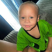 Kaysion is registered to the contest to win money with this photo: toddler, child, baby, portrait, face, smiling, eyes, green_shirt, clothing, sitting, couch, sofa, indoor, window, curtain, daylight, closeup, home, person, photography