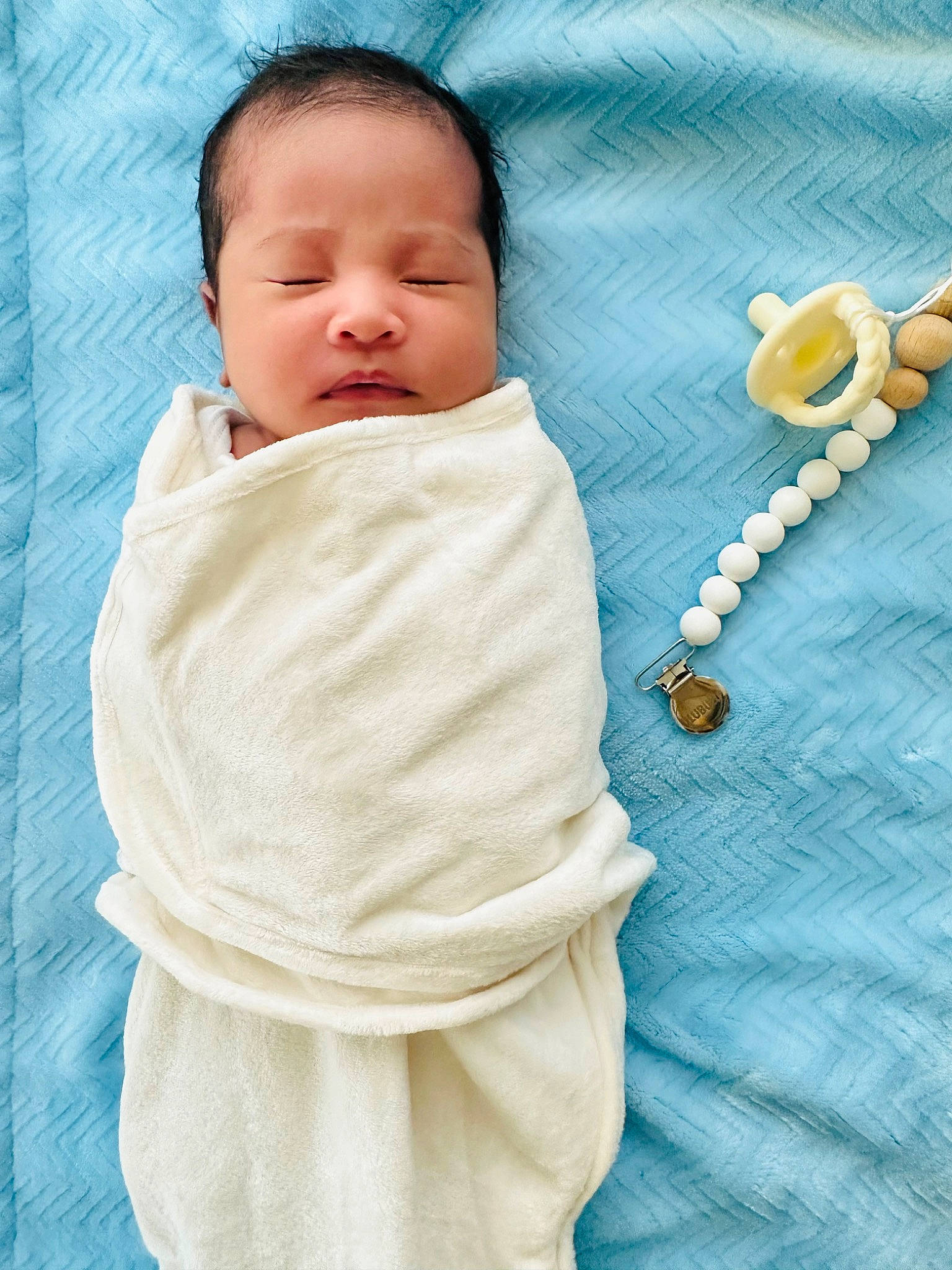 Stephen John is registered to the contest to win money with this photo: baby, baby_products, baby_sleeping, baby_toddler_clothing, bedding, bedtime, child, comfort, electric_blue, fashion_accessory, fur, happy, jewellery, linens, pattern, person, skin, sleeve, t_shirt, textile