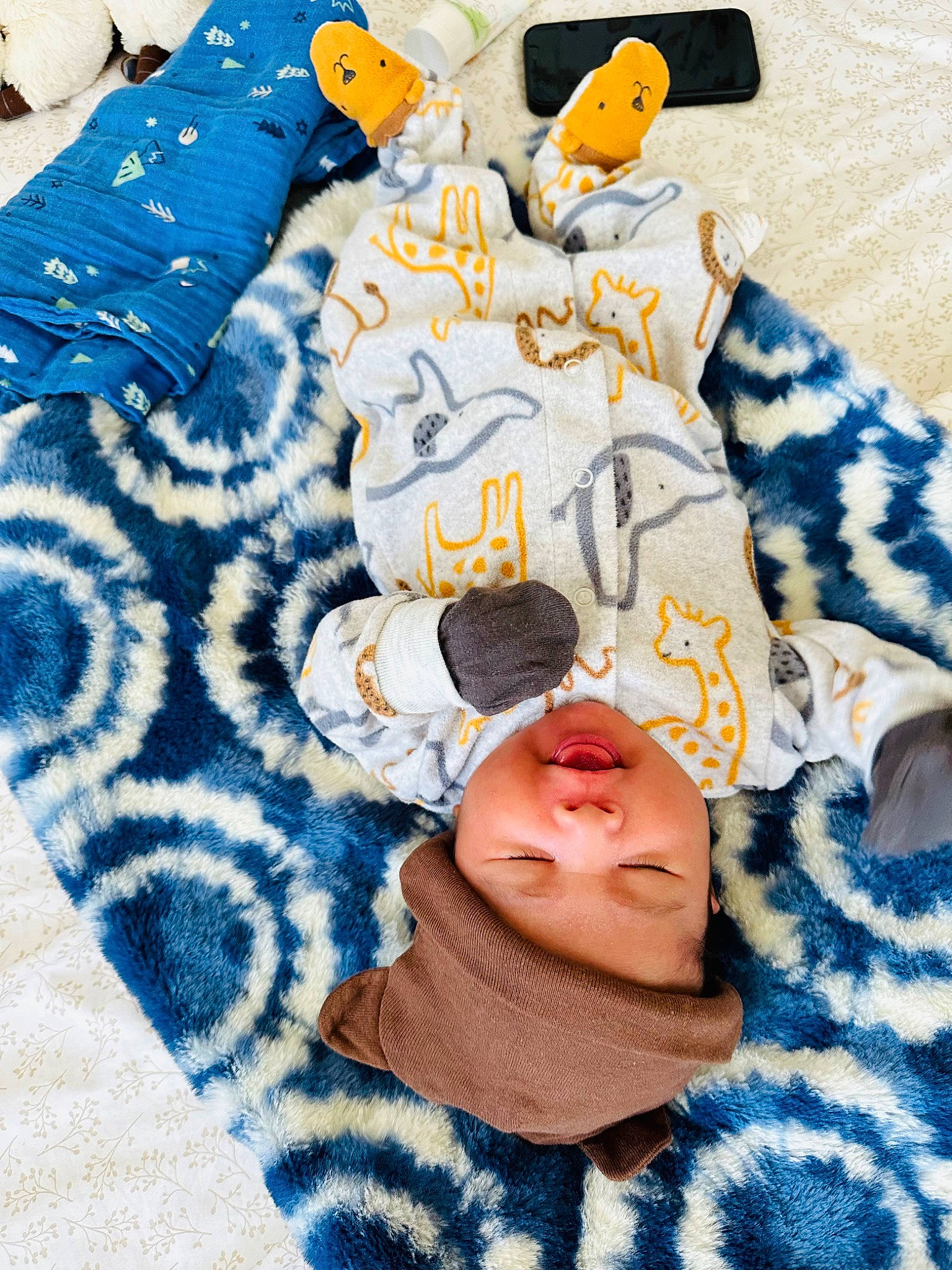Stephen John is registered to the contest to win money with this photo: baby_toddler_clothing, bed, bed_sheet, bedding, blue, comfort, cushion, electric_blue, fashion_accessory, font, fur, headwear, linens, orange, pattern, person, room, sleeve, sportswear, t_shirt