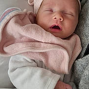 Ambre participe au concours pour gagner de l'argent avec cette photo : baby, sleeping, infant, pink_towel, white_clothing, cap, cute, peaceful, hand, soft_texture, blanket, closeup, resting, newborn, wrapped, cozy, indoors, portrait, child, wearing