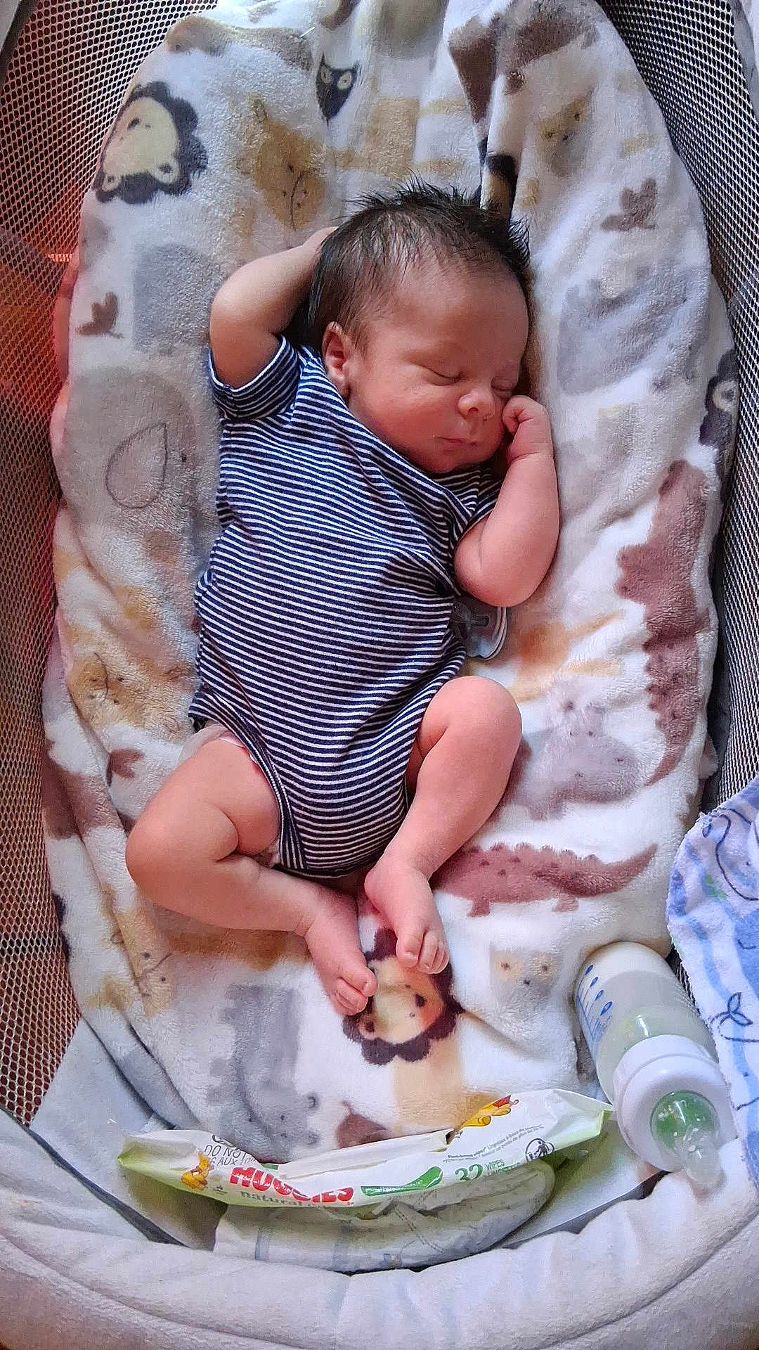 David Jr. is registered to the contest to win money with this photo: baby, newborn, infant, sleeping, striped_onesie, onesie, blanket, bassinet, crib, bottle, baby_wipes, pacifier, feet, hand, hair, animal_print, mesh_side, cozy, cute, portrait_photography