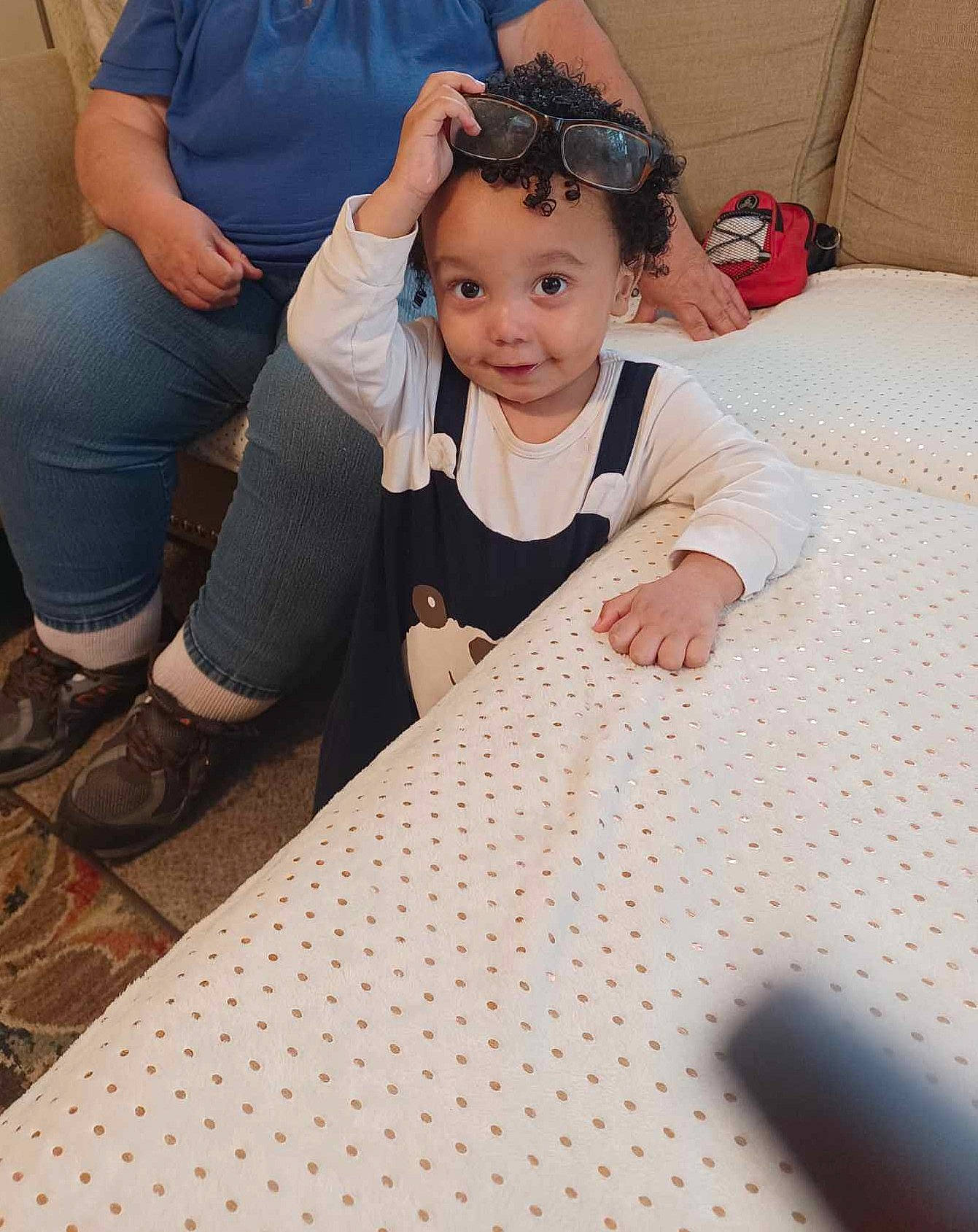 Lorenzo is registered to the contest to win money with this photo: child, clothing, event, eyewear, fashion_design, floor, flooring, formal_wear, fun, happy, jewellery, linens, pattern, person, sitting, sleeve, smile, sunglasses, t_shirt, tablecloth