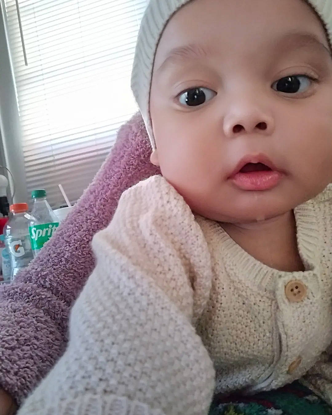 Lorenzo joined the competition — help win amazing prizes! baby, baby_toddler_clothing, bottle, cap, cheek, child, eyelash, fashion_accessory, headwear, lip, nose, outerwear, pattern, person, skin, sleeve, toddler, water_bottle, window, wool