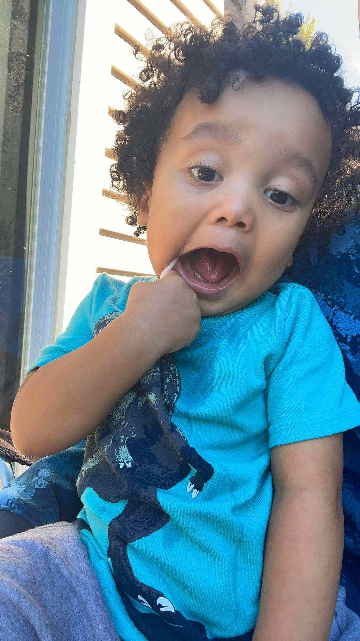 Lorenzo is registered to the contest to win money with this photo: arm, azure, baby_toddler_clothing, blue, cheek, child, cool, curtain, electric_blue, gesture, happy, iris, mouth, neck, nose, person, shoulder, skin, sleeve, surprise