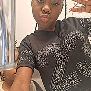 Darra is registered to the contest to win money with this photo: child, girl, selfie, peace_sign, black_shirt, studs, braids, indoor, person, portrait, casual, smile, hand_gesture, young, face, arm, mirror, reflection, metallic_object, background